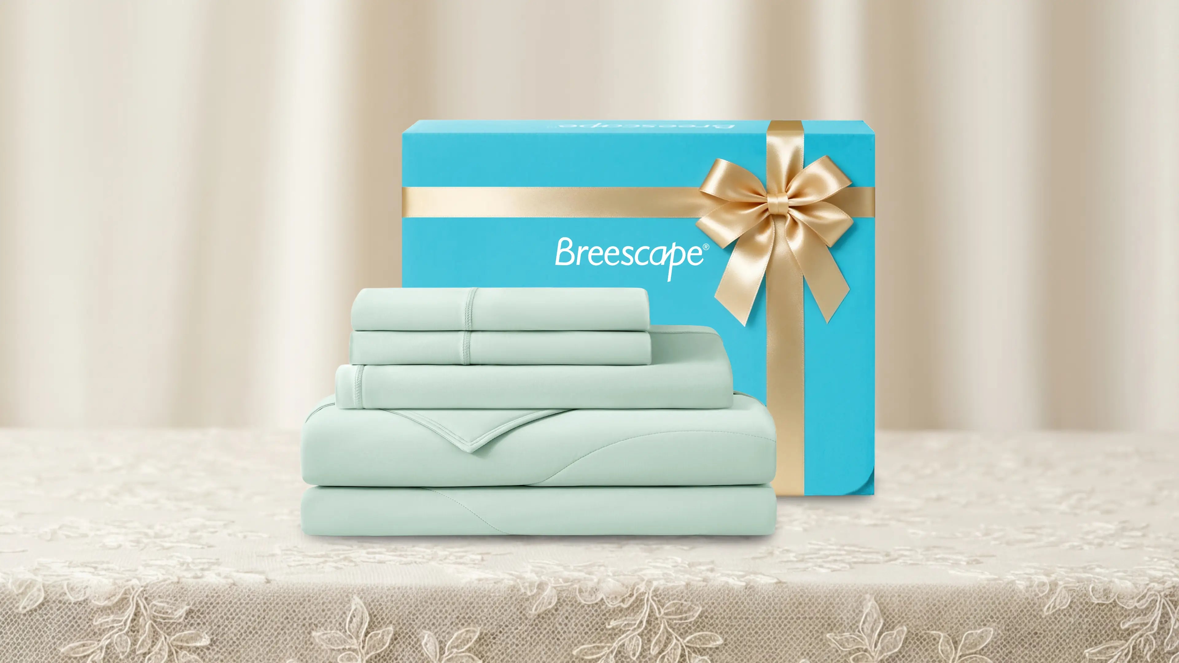 Breescape bedding set with a blue box and gold ribbon on a neutral background