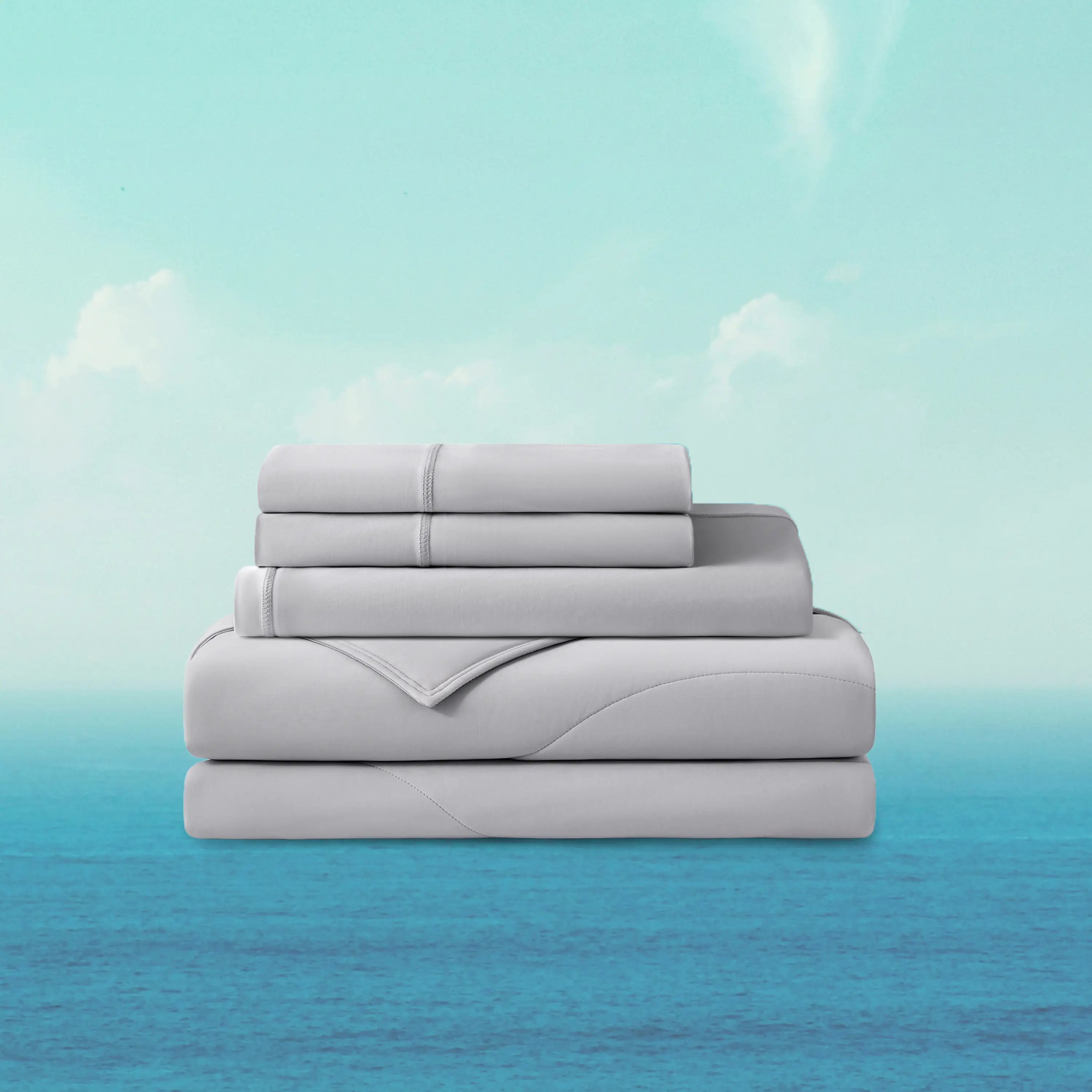 Stack of light gray bedding sheets on a gradient blue background