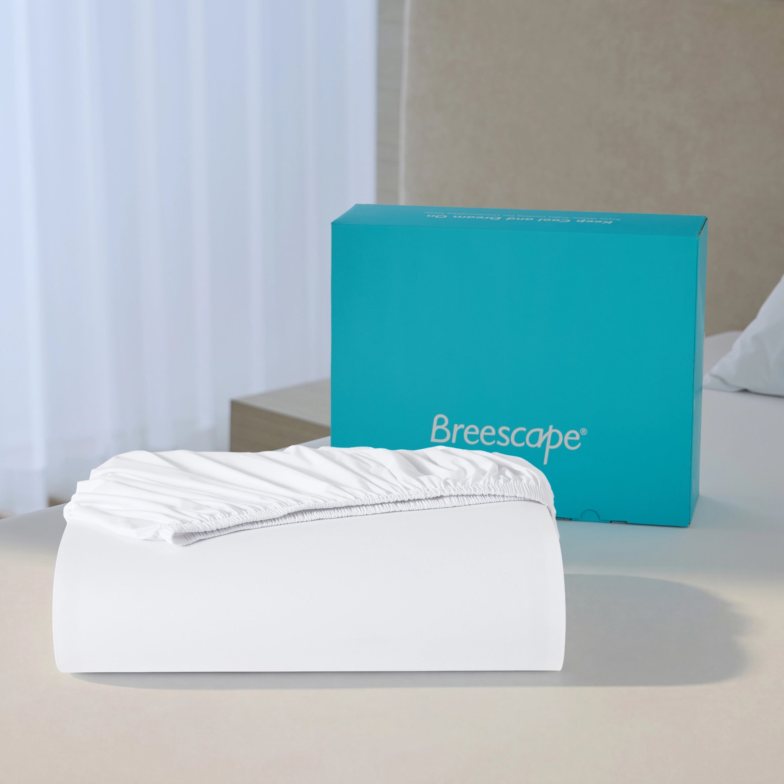 Snow white Breescape breathable cooling fitted sheet on bed, teal box