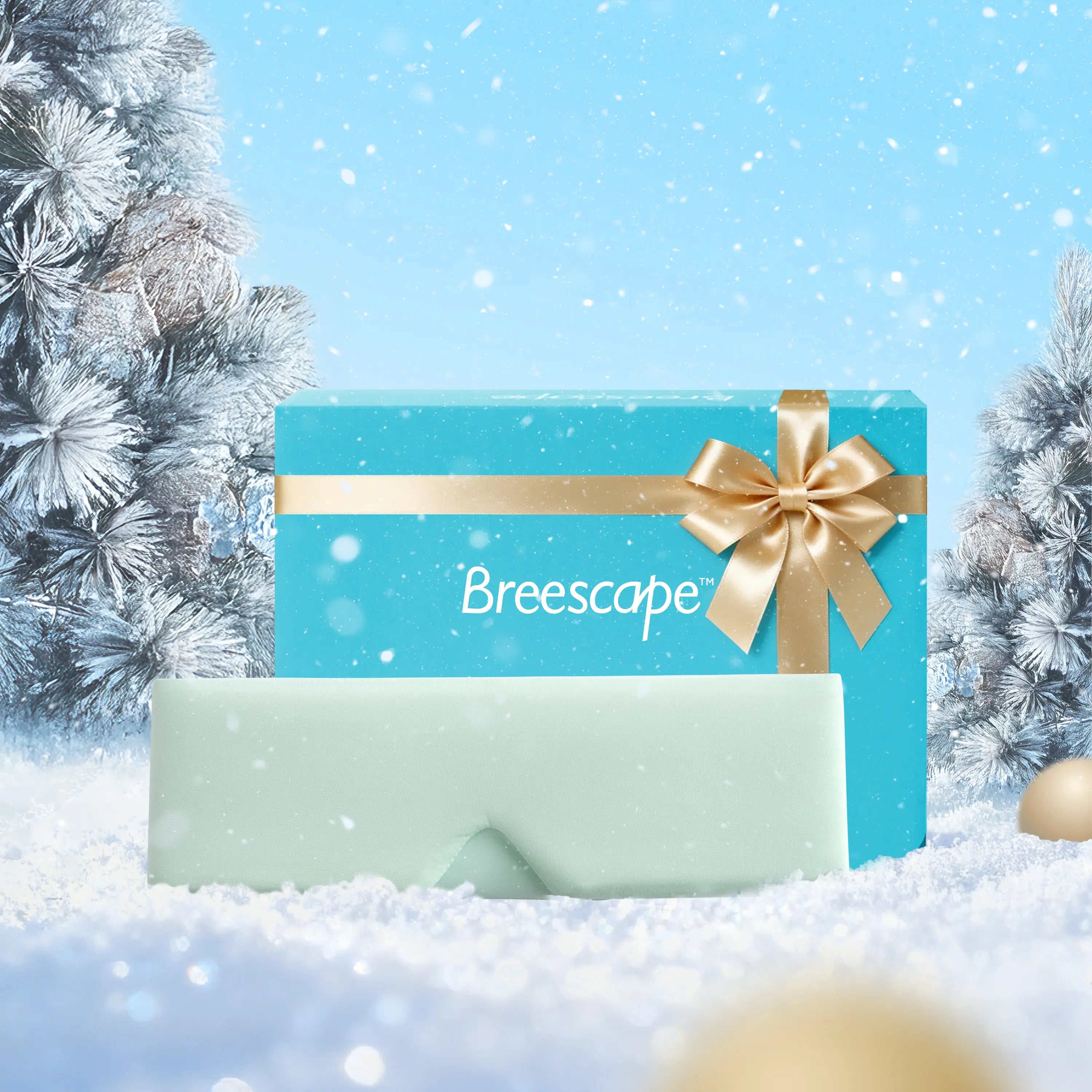 Gift card with gold bow and 'Breescape' branding against a snowy background