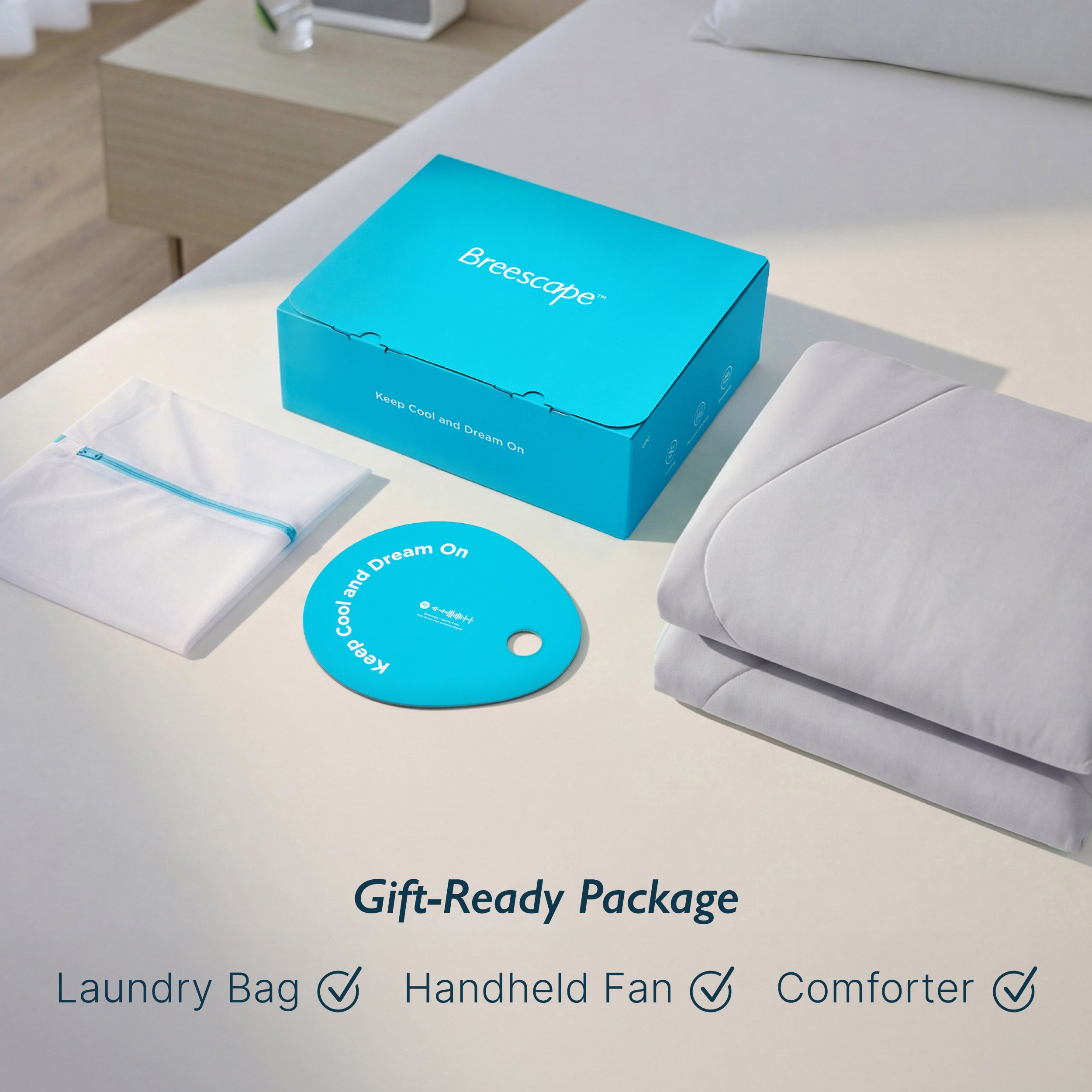 Breescape misty grey cooling comforter gift package with laundry bag and handheld fan.
