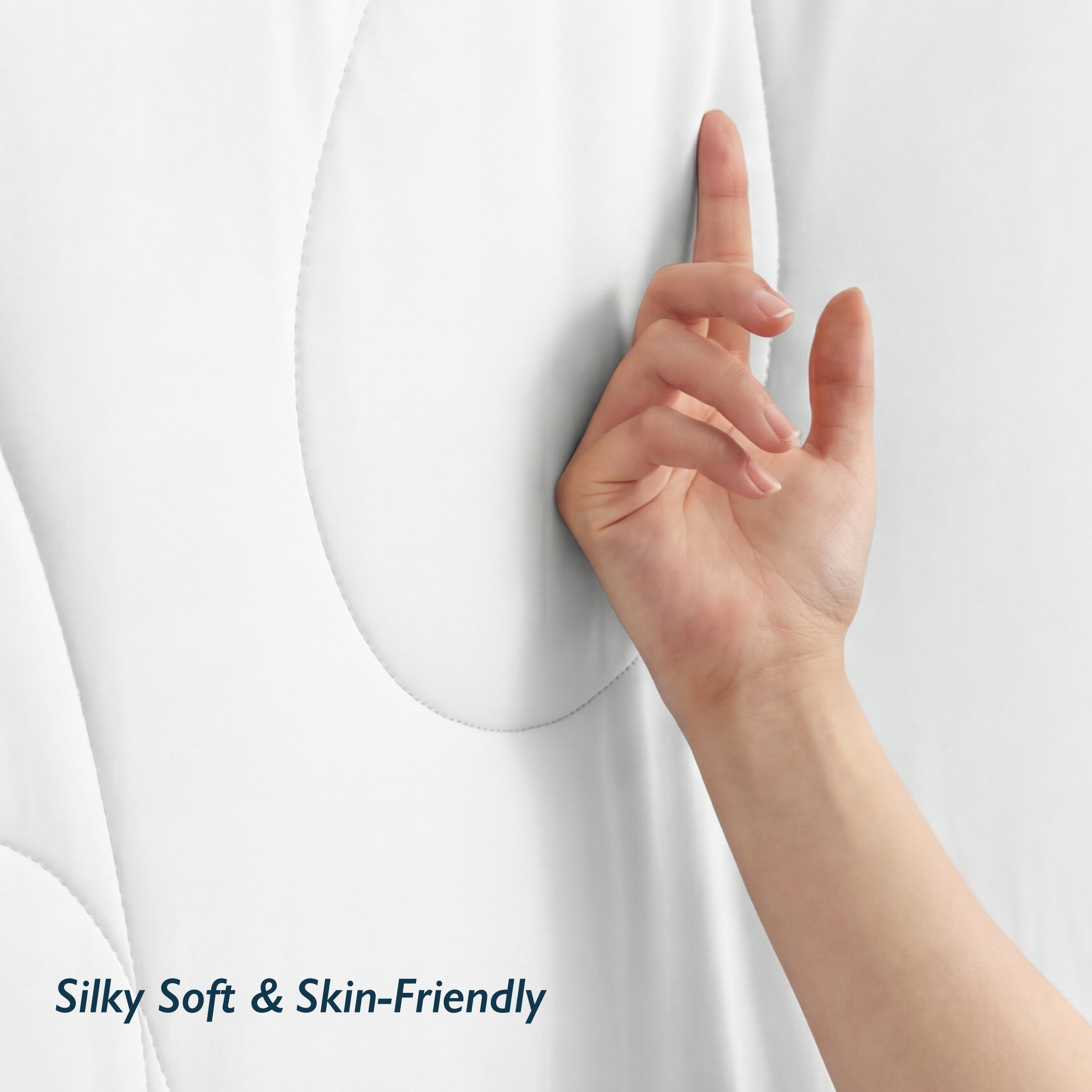 Hand touching silky soft snow white Breescape cooling comforter for night sweats.