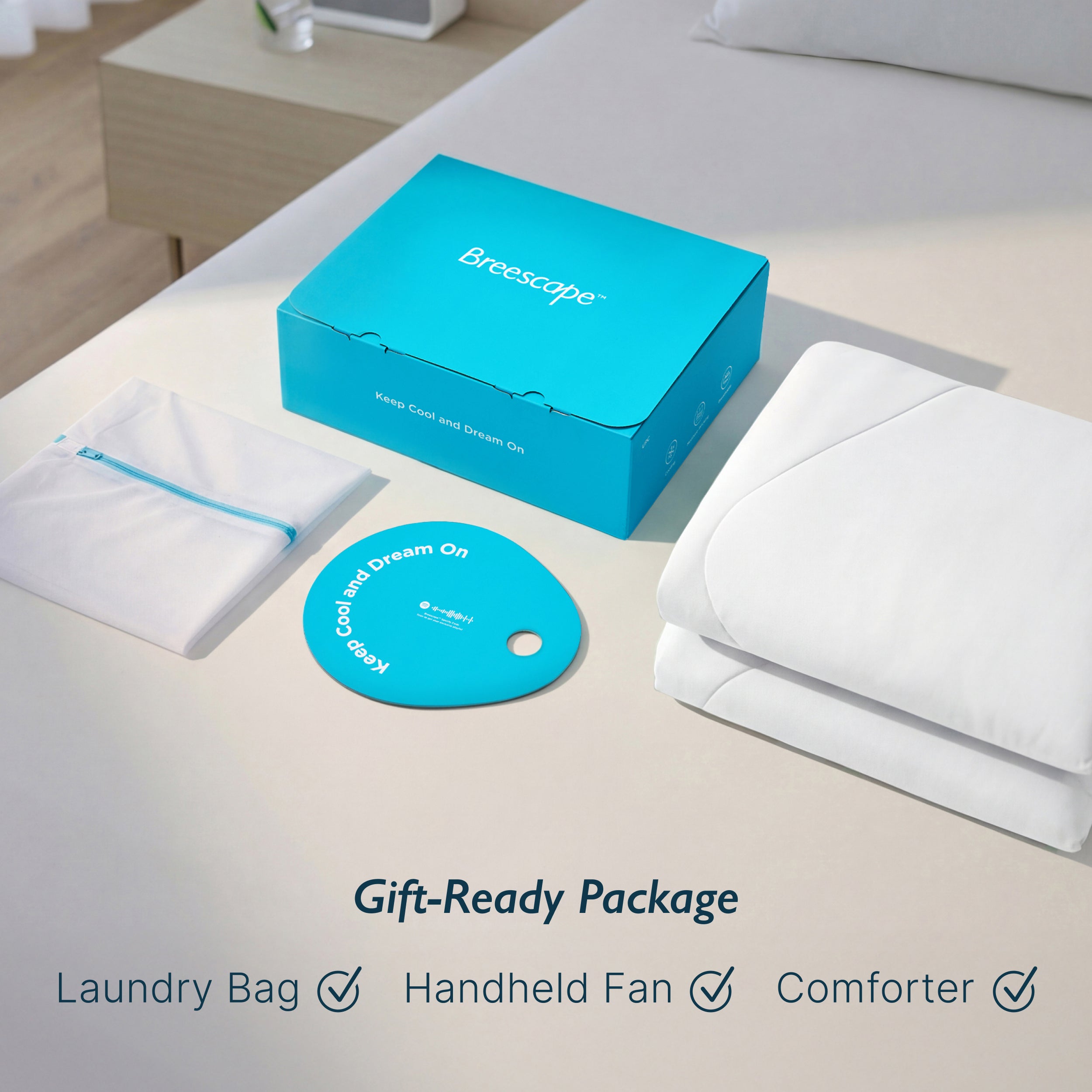 Breescape gift-ready package: snow white cooling comforter, laundry bag, fan.