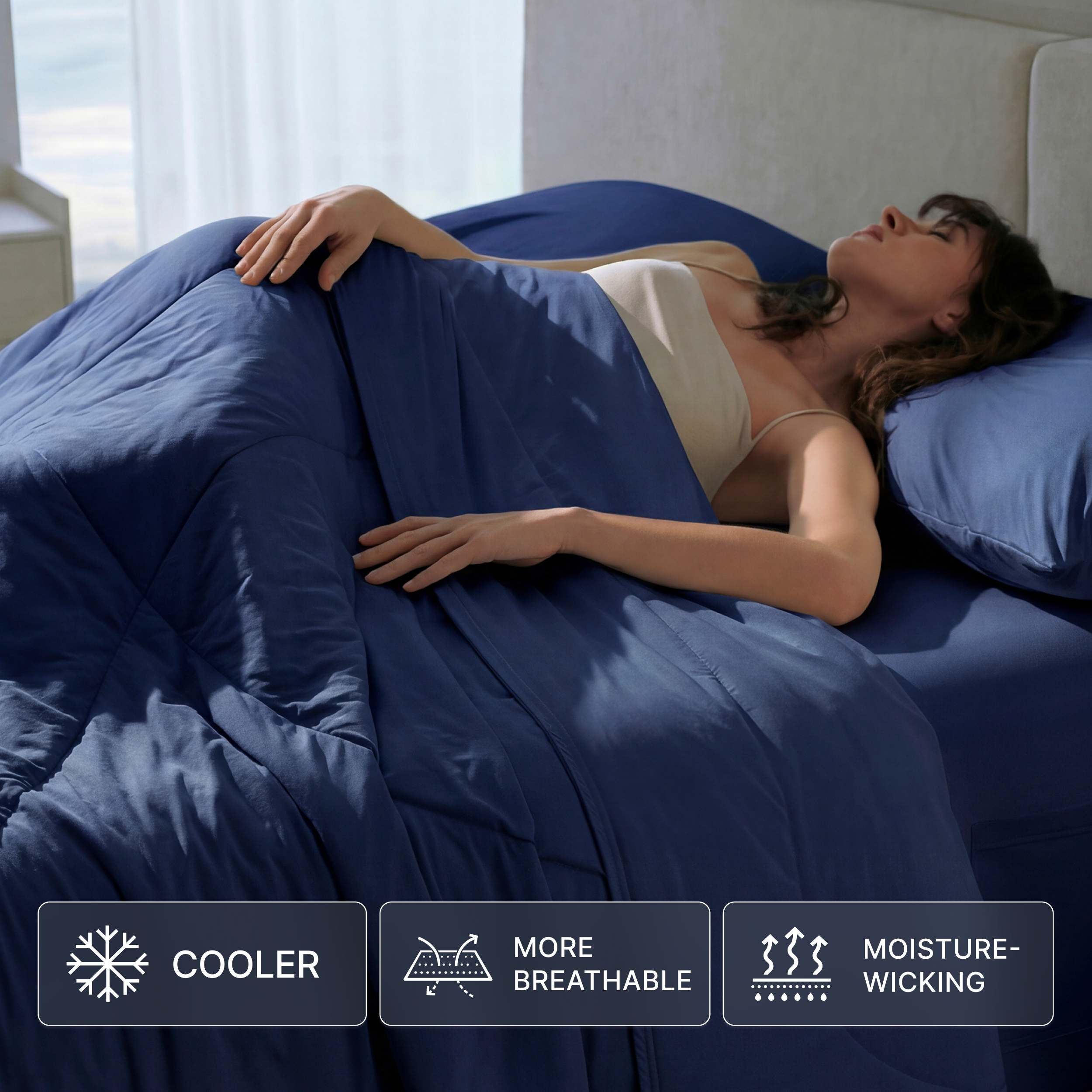 Breescape cooling comforter in twilight blue, woman sleeping. Features: cooler, breathable, moisture-wicking for hot sleepers.