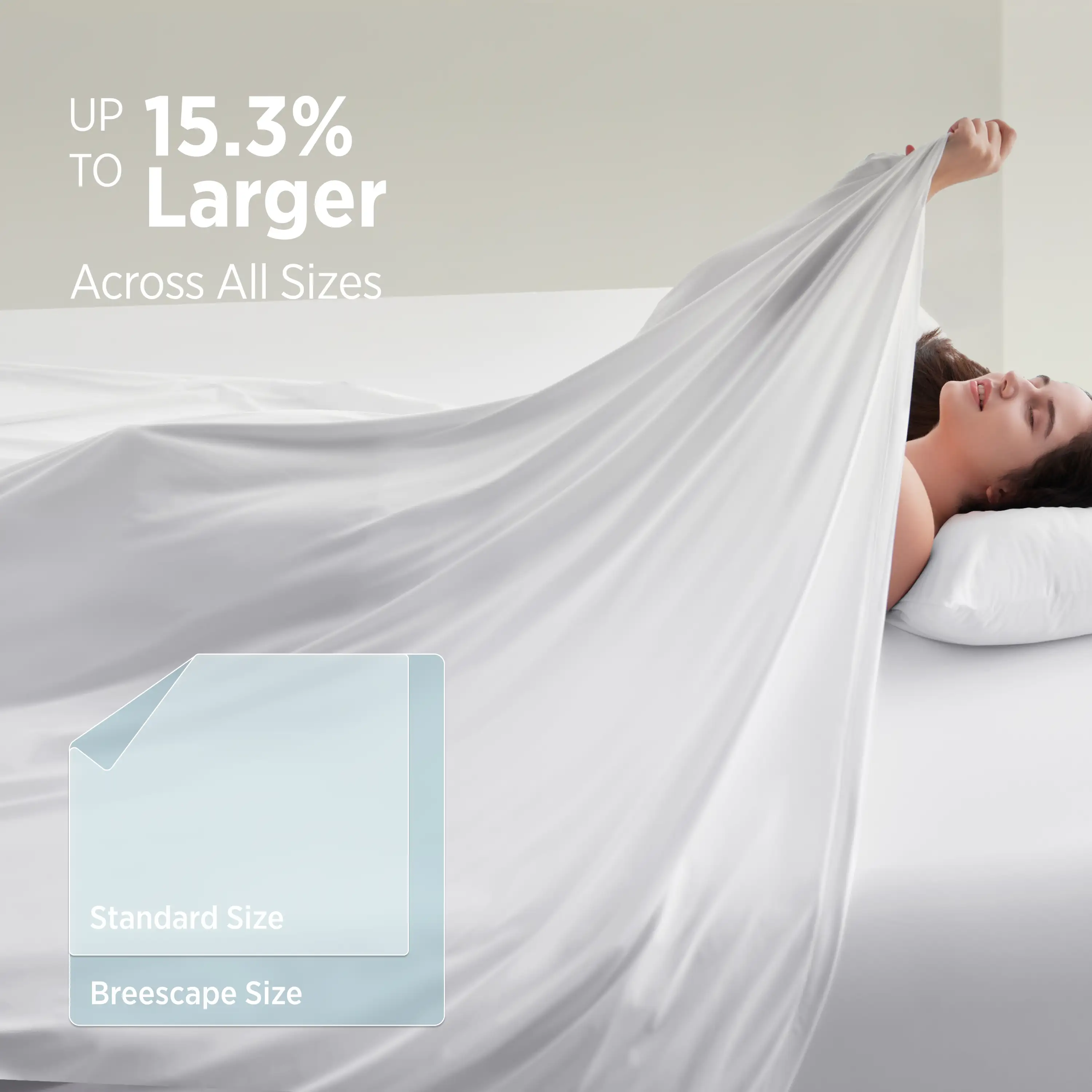 Woman lying on a bed with a large white sheet draped over her, promoting a product size comparison. #color_snow-white