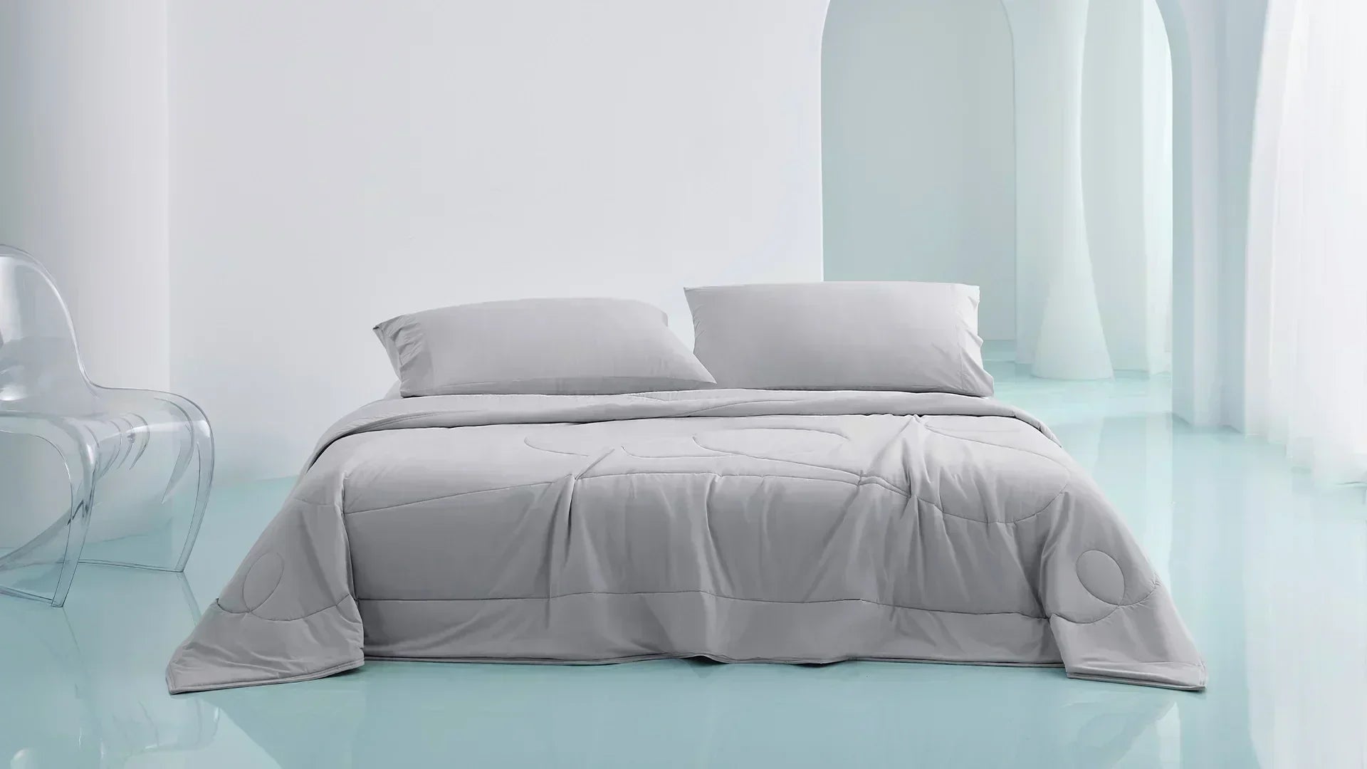 Modern grey bedding set in a minimalist room with glossy light blue floors and white arched walls