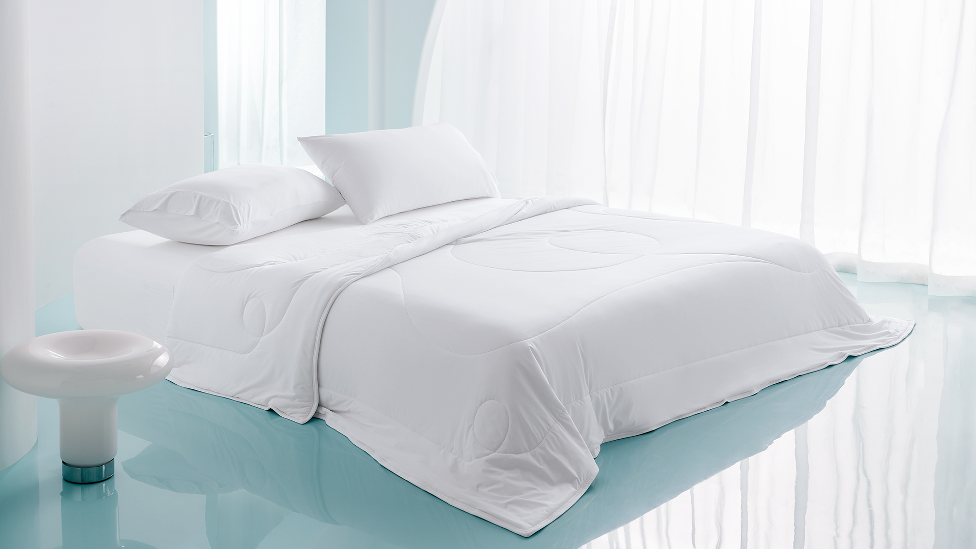 White high-performance cooling comforter with BlendTek technology on a bed, highlighting its breathable fabric and moisture-wicking surface for hot sleepers.