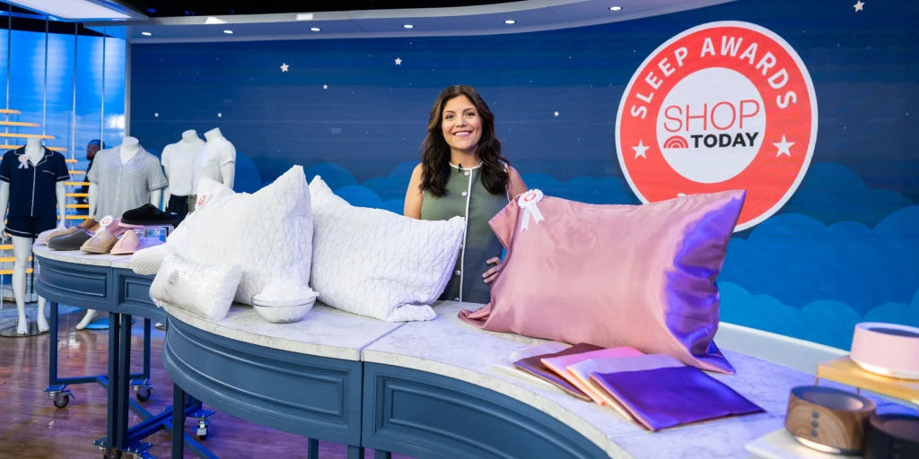 Woman presenting pillows on a set with 'Sleep Awards' and 'Shop Today' branding.