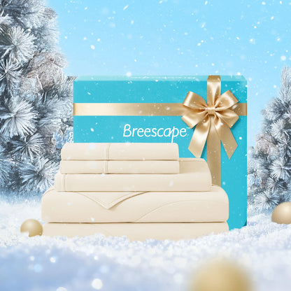 Stack of folded towels with a blue gift box featuring a gold ribbon and 'Breescape' branding, set against a snowy background.