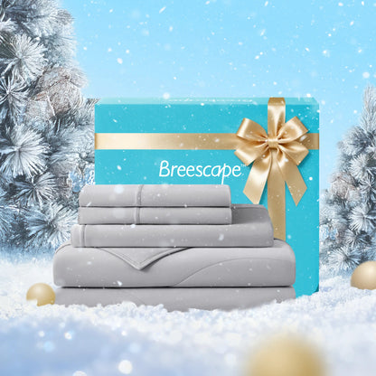 Gray bedding set with a blue gift box labeled 'Breescape' against a snowy background.