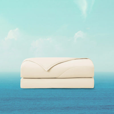 Folded beige blanket on a blue and green gradient background