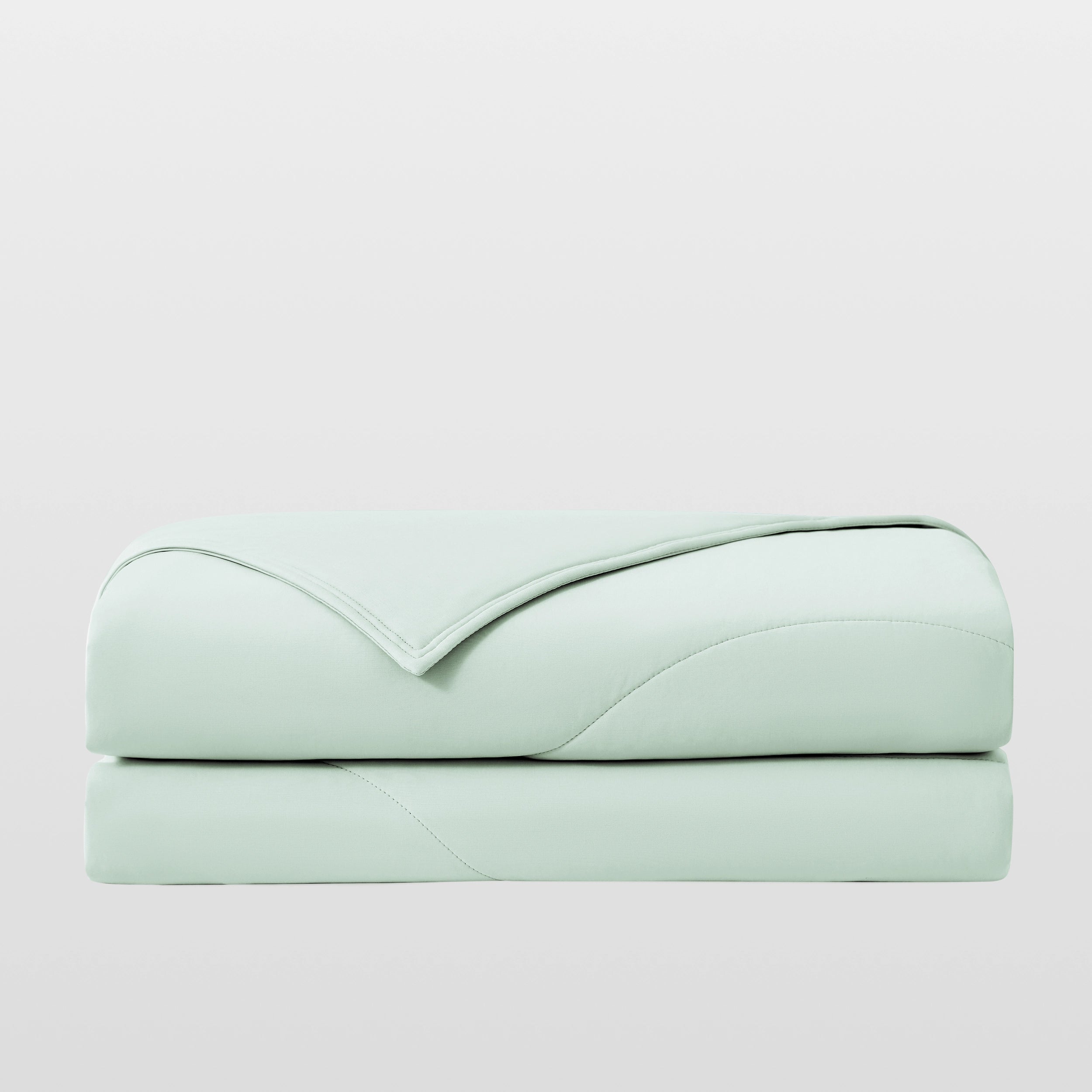 Breescape mint green cooling comforter, breathable & folded for hot sleepers.