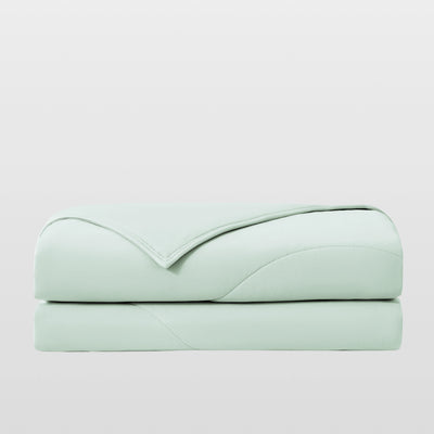 Breescape mint green cooling comforter, breathable & folded for hot sleepers.