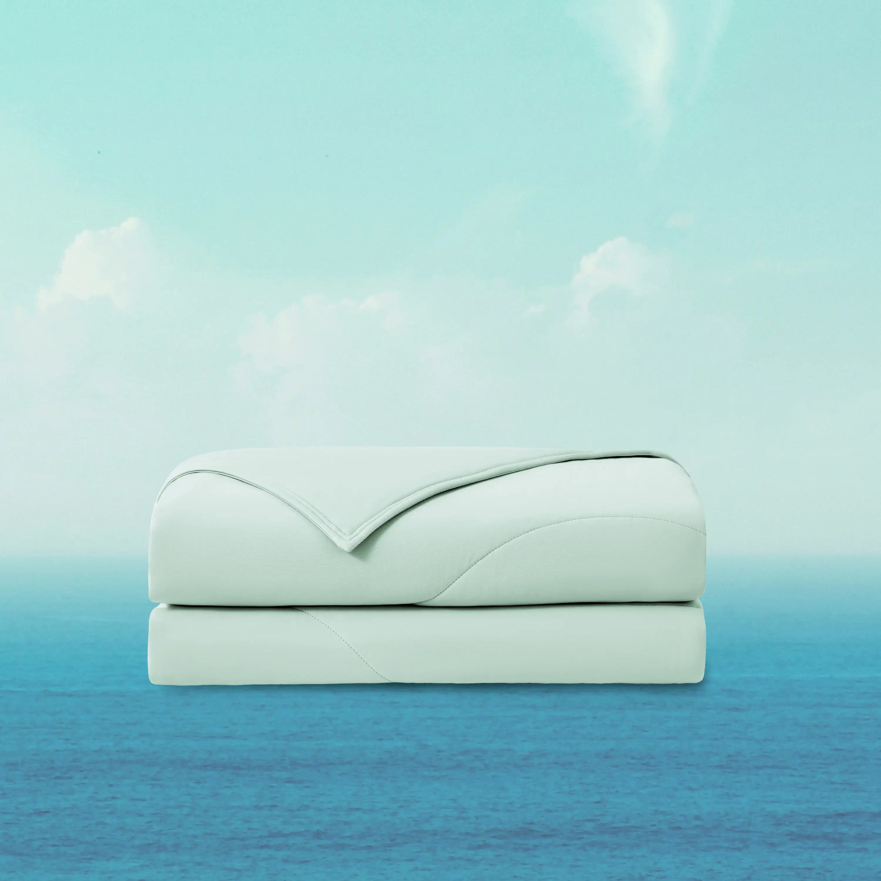 Folded light blue blanket on a gradient background