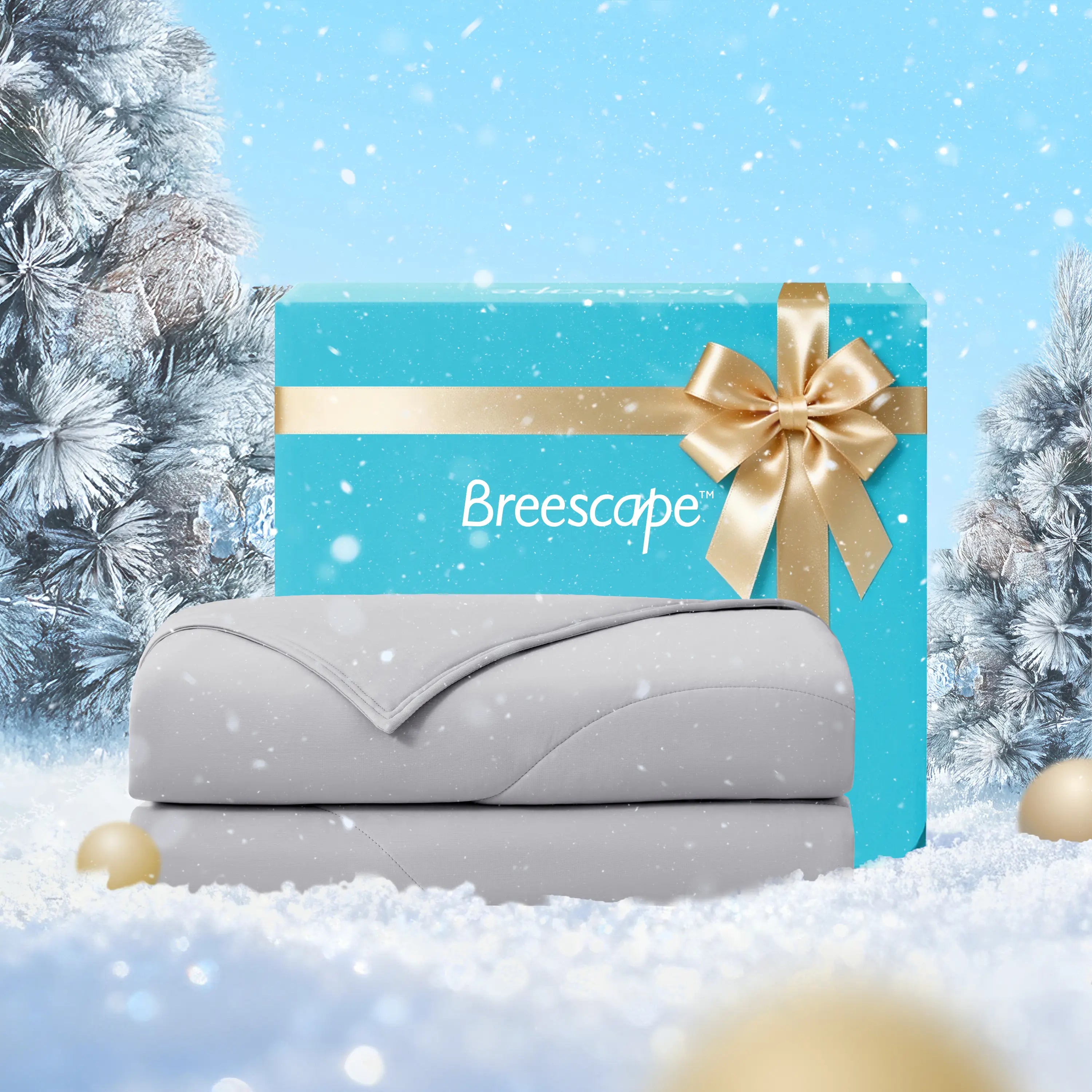 Gray mattress with a blue Breescape box featuring a gold ribbon against a snowy background