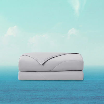 Folded gray blanket on a gradient background