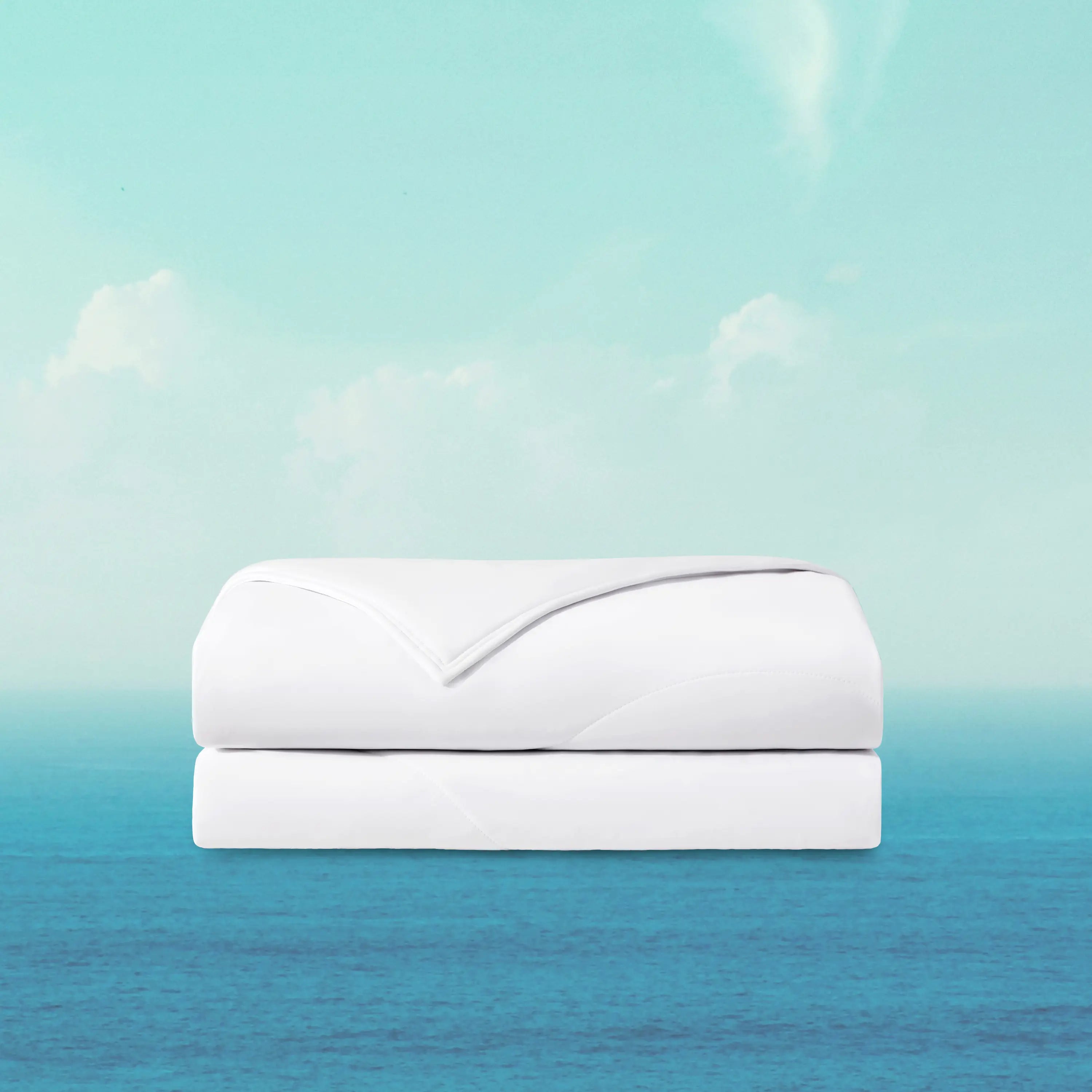 White quilt on a blue and green gradient background