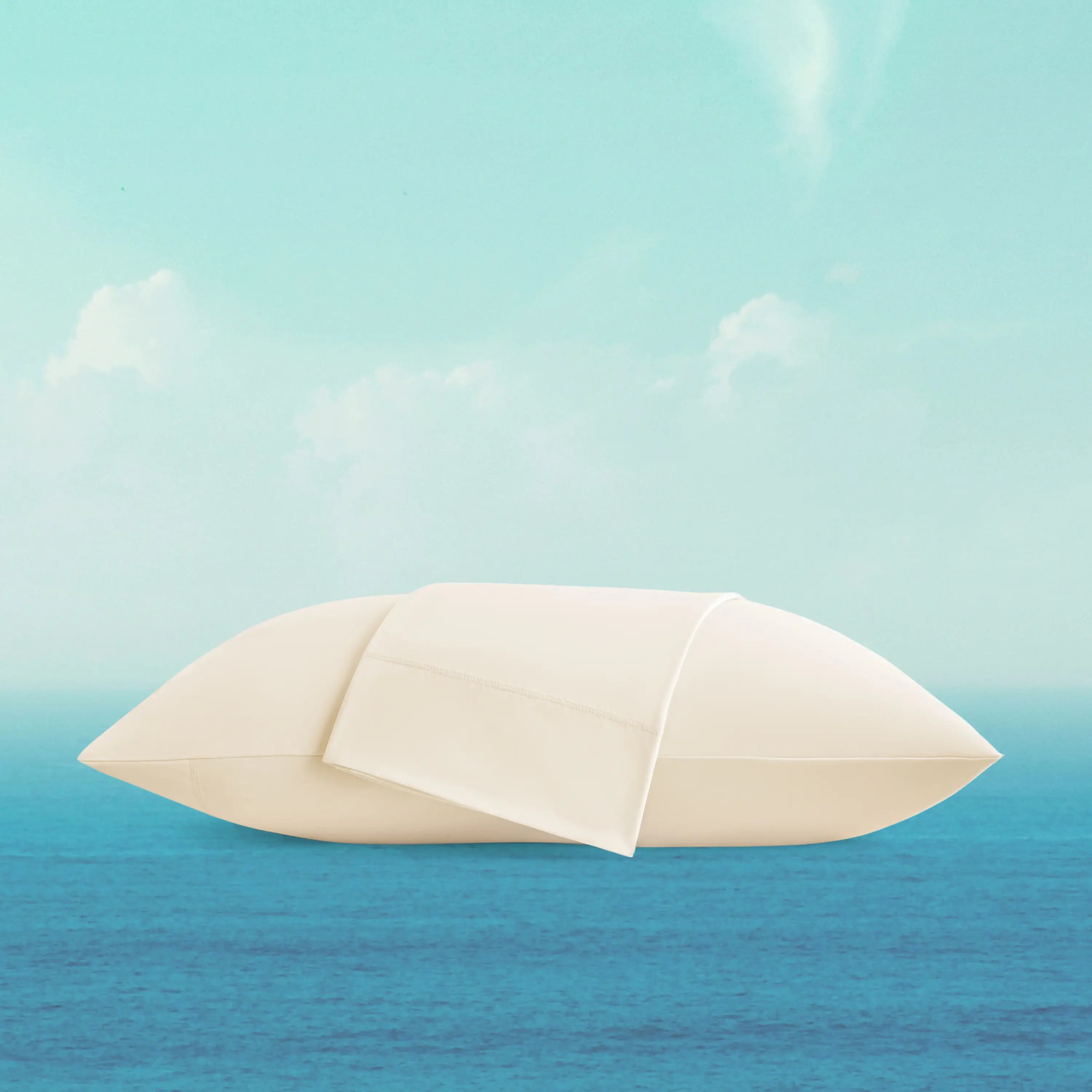 White sailboat on a blue ocean with a light blue sky