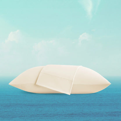 White sailboat on a blue ocean with a light blue sky