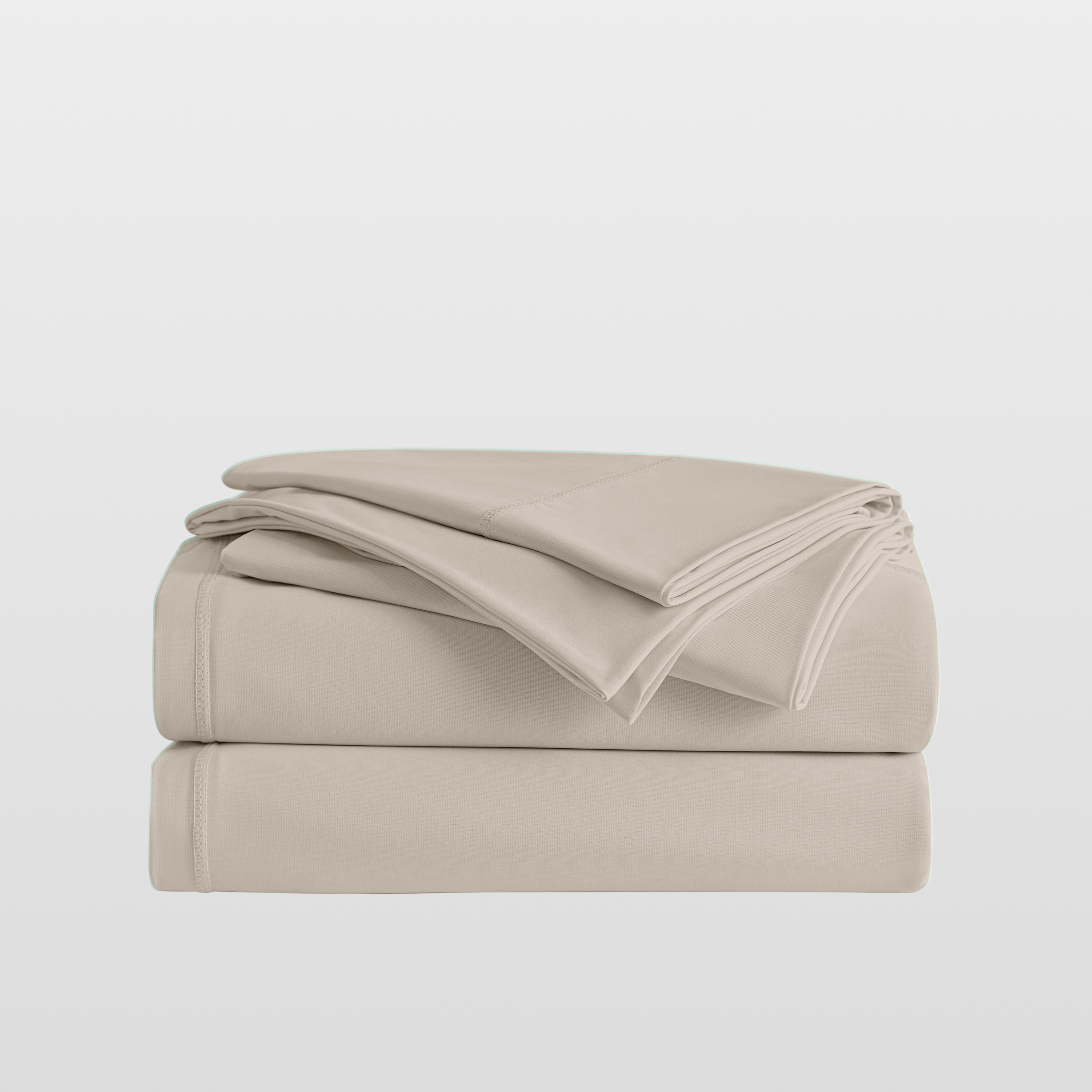 Beige bed sheets folded on a light gray background