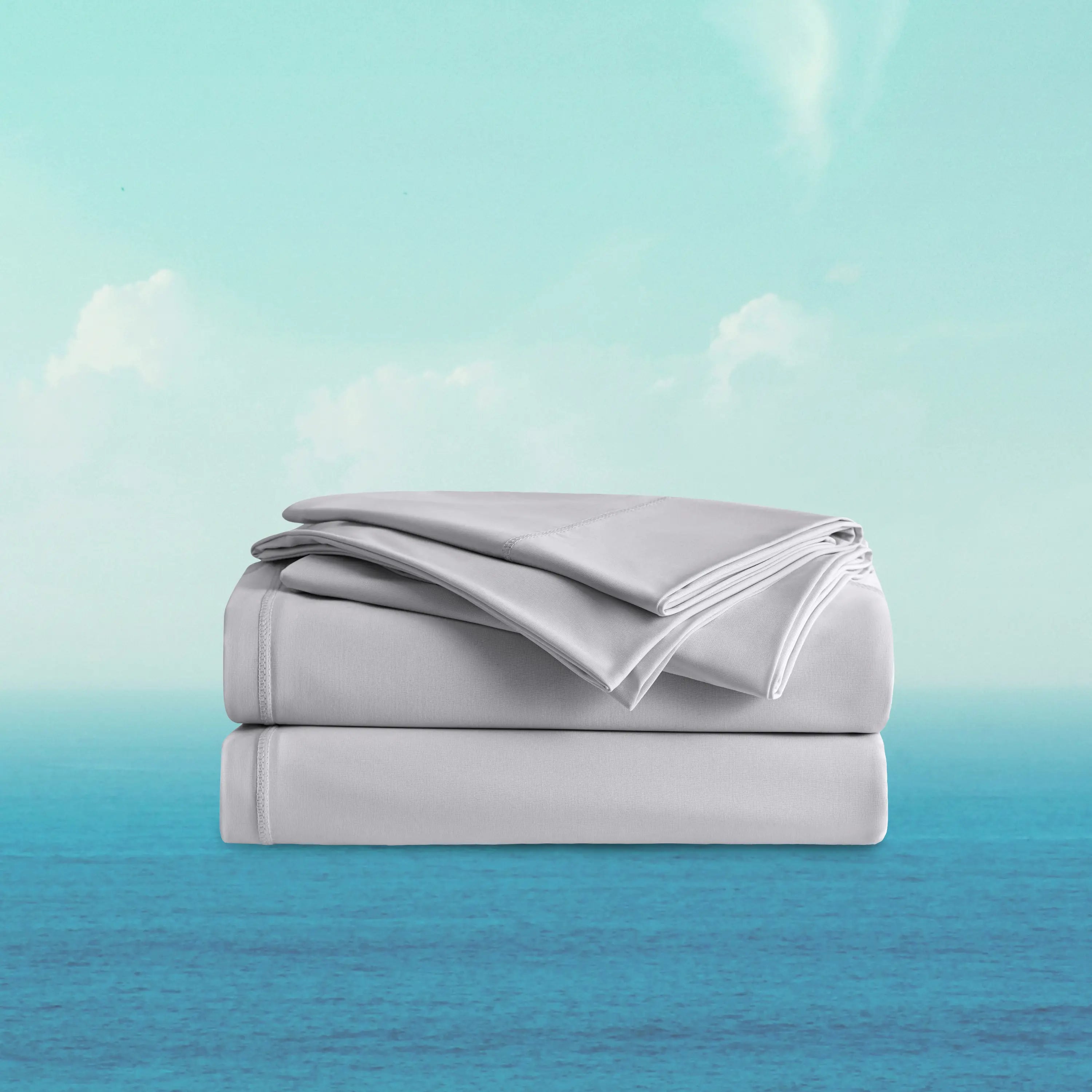 Folded gray bed sheets on a gradient background