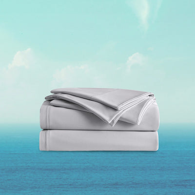 Folded gray bed sheets on a gradient background