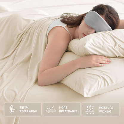 Woman sleeping with a gray sleep mask on, covered with a beige blanket. #color_ivory