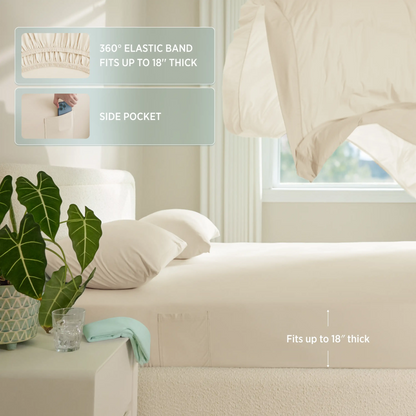Beige fitted sheet with elastic band and side pocket on a bed in a bedroom setting. #color_ivory