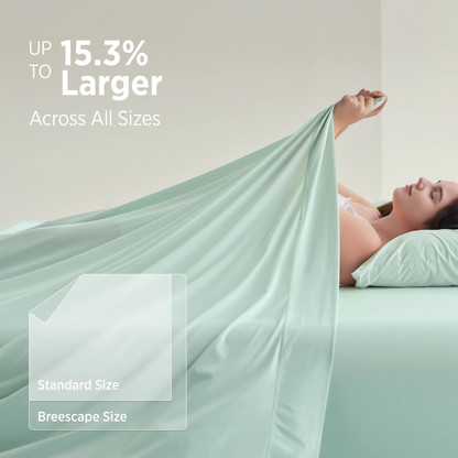 Person lying in bed with a green sheet, showing a comparison between standard and Breescape sizes.  #color_mint-green