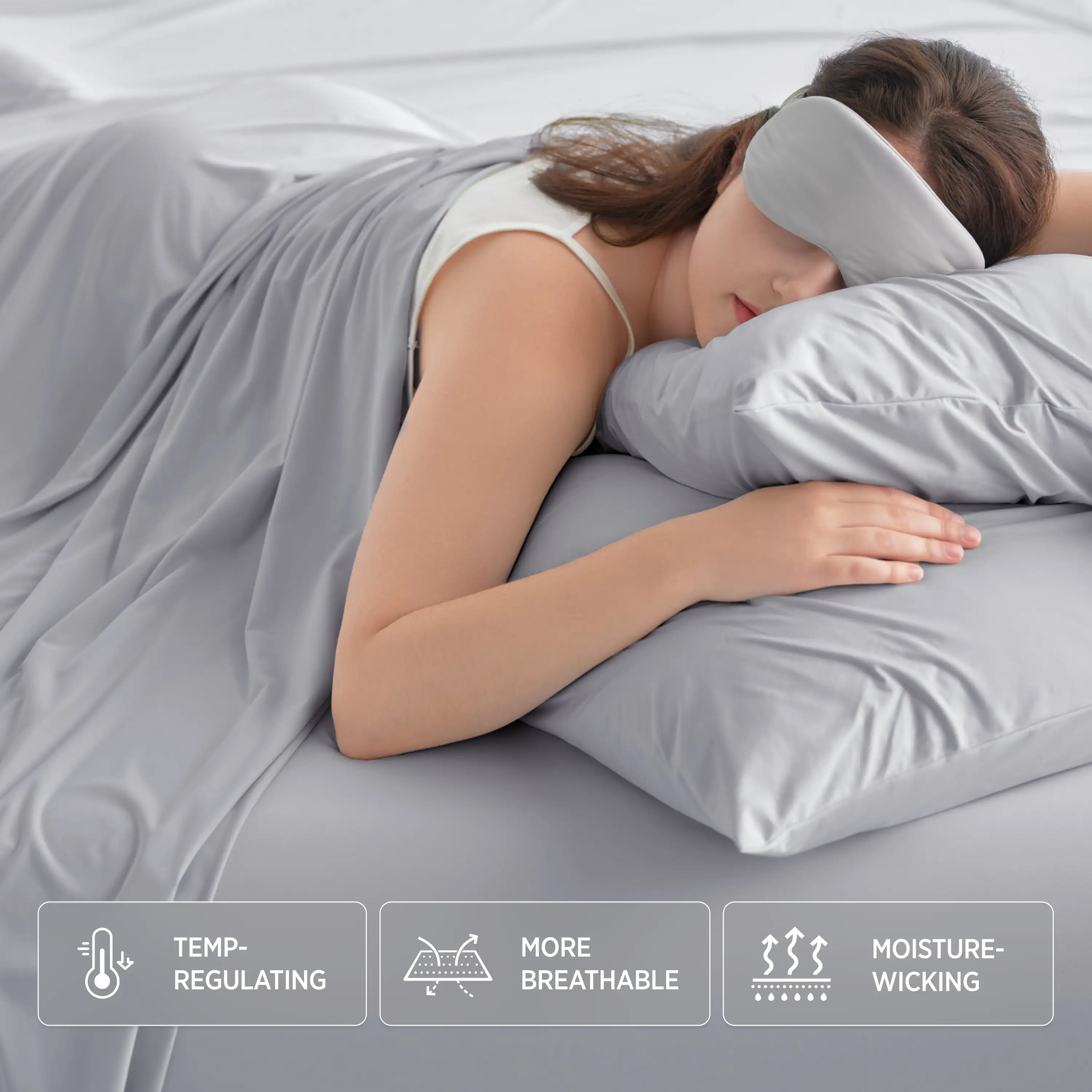 Woman sleeping with a gray pillow and eye mask, surrounded by gray bedding. #color_misty-grey