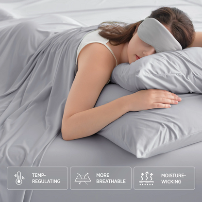 Woman sleeping with a gray pillow and eye mask, surrounded by gray bedding. #color_misty-grey