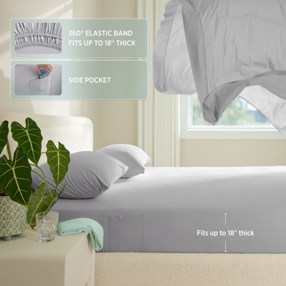 Gray fitted sheet with elastic band and side pocket on a bed in a bedroom setting. #color_misty-grey