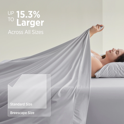 Woman sleeping on Breescape cooling sheets, UP TO 15.3% Larger Across All Sizes. Misty grey.