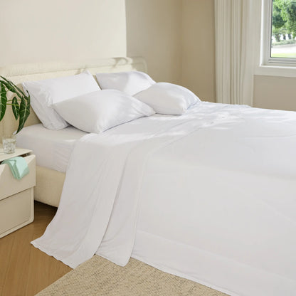 Bed with white bedding in a bedroom setting #color_snow-white