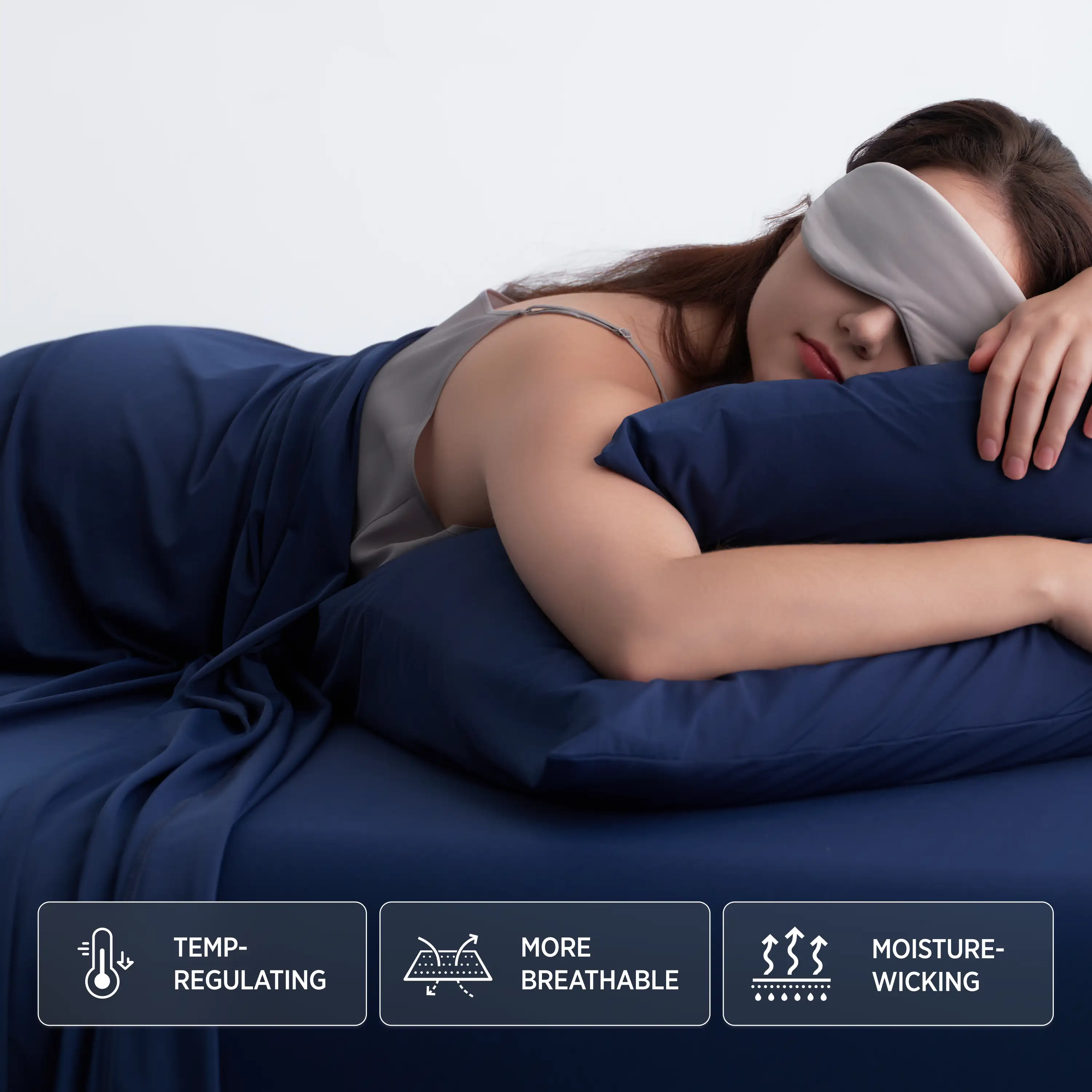 Woman lying in bed with a sleep mask on, wearing a nightgown, with text labels about product features. #color_twilight-blue