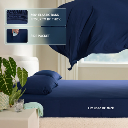 Navy blue fitted sheet with elastic band and side pocket on a bed in a room. #color_twilight-blue