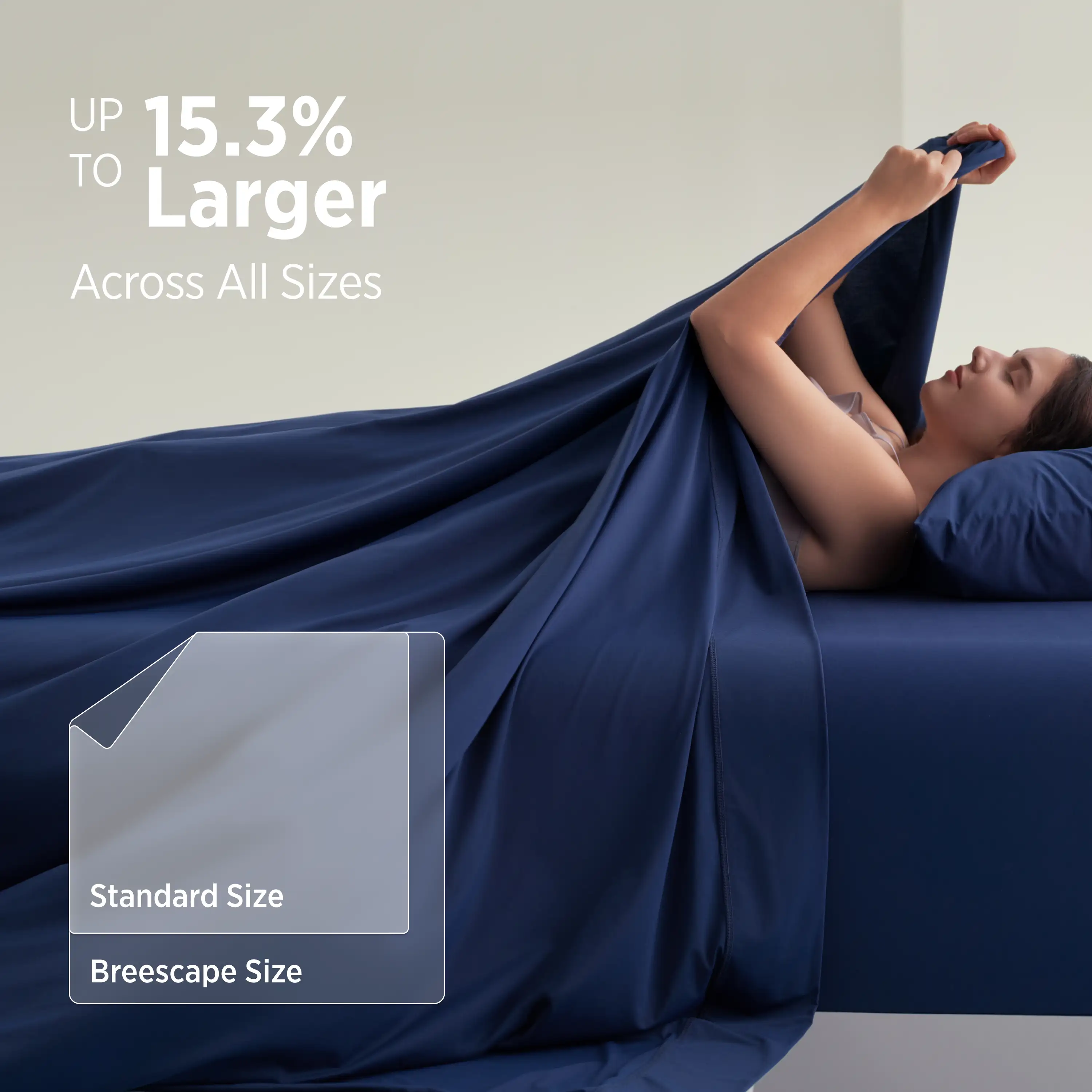 Woman lying under a large blue blanket with text about size comparison. #color_twilight-blue