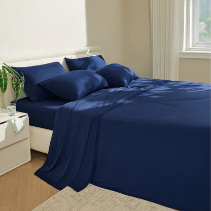 Navy blue satin sheet set on a bed in a bedroom. #color_twilight-blue